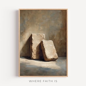 May include: A framed print featuring two stone tablets with inscribed text, rendered in a painterly style. The artwork has a neutral color palette with warm tones and a soft, diffused light. The text "WHERE FAITH IS" is at the bottom.