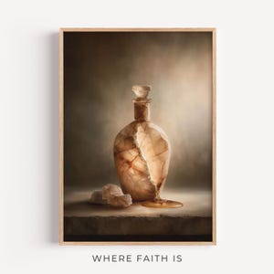 May include: A framed art print showing a decorative bottle with a stopper. The bottle has a textured, cracked design and a golden liquid spilling out. The words "WHERE FAITH IS" are printed at the bottom of the image.