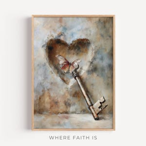 May include: A framed artwork depicting a heart-shaped void with a butterfly on a vintage key. The key is a rusty brown colour, and the butterfly has reddish-brown wings. The background has a textured, painterly effect. The text "WHERE FAITH IS" is at the bottom.