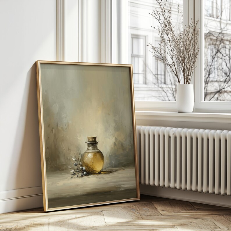 May include: A framed art print featuring a still life of a glass bottle with a cork stopper, filled with a golden liquid. The painting includes a sprig of leaves and berries, set against a muted, neutral background. The frame is gold.