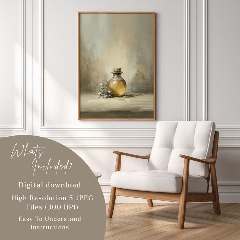 May include: A framed digital art print featuring a still life of a glass bottle with a cork stopper, olive sprigs, and a soft, neutral background. The artwork is in a wooden frame and is displayed on a wall. The image also shows a white chair.