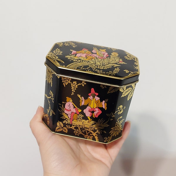 English biscuit tin featuring Chinoiserie motifs of musicians in pastoral scenes -collectible sweets tin - England - black gold pink orange