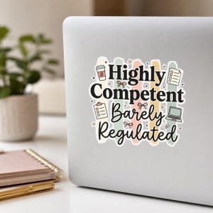 May include: A white sticker with the text "Highly Competent Barely Regulated" in black, with colorful accents. The design includes coffee cup, notepad, laptop, and star illustrations. The sticker is on a laptop.