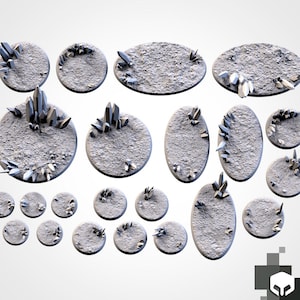 May include: A collection of gray, textured, circular and oval bases with crystal formations. The bases vary in size and shape, with crystals of different sizes and arrangements. The crystals are a light gray color, contrasting with the darker gray bases.