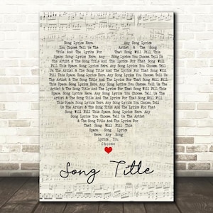 May include: A framed print featuring sheet music with a heart and the words "Song Title." The lyrics are arranged in a heart shape, with the words "Song Lyrics Here" and "Any Song Lyrics" visible. The background is a light beige.