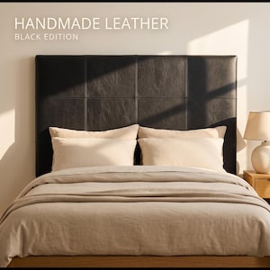 May include: A bed with a black leather headboard, beige pillows, and a beige comforter. The headboard is divided into rectangular sections. The text "HANDMADE LEATHER BLACK EDITION" is at the top of the image.
