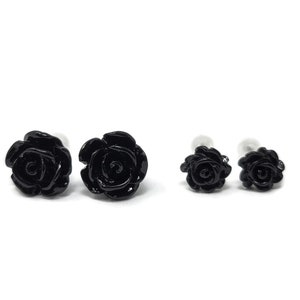 May include: Three black rose earrings, two larger and one smaller.