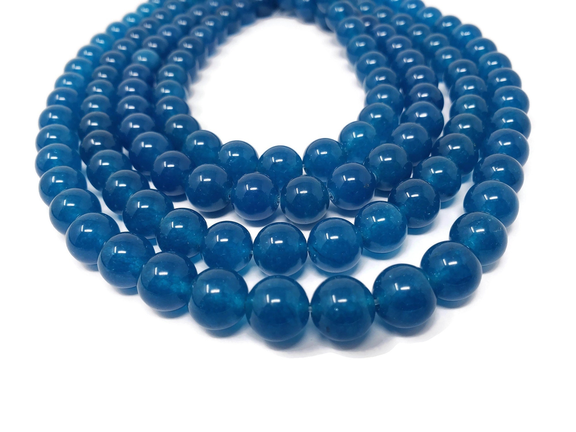 thumbnail interactive-video image 1 of Wholesale 10mm Natural Blue Jade Round Gemstone Beads – 15 Strand Loose 1 of 5