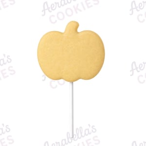 May include: A light beige pumpkin-shaped biscuit on a thin white stick. The biscuit has a smooth, flat surface and a distinct stem at the top. The background features a repeating watermark of the text Aerabella's COOKIES in a light pink colour.