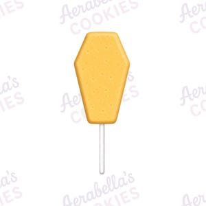 Peut inclure: Un biscuit en forme de cercueil sur un bâtonnet blanc. Le biscuit présente une surface texturée jaune doré. L'arrière-plan comporte un motif en filigrane répétitif et clair du texte Aerabella's COOKIES sur toute l'image.