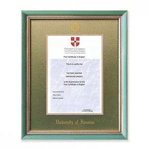 May include: A framed certificate with a green and gold border. The certificate is for the First Certificate in English, issued by the University of Cambridge. The text "University of Houston" is visible at the bottom.