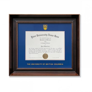 May include: A framed university diploma featuring a dark brown wooden frame, a deep blue mat, and a gold university crest. The document displays the text Your University Name Here, Bachelor of Science in Computer Science, and The University of British Columbia.