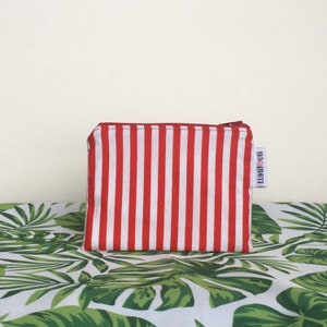 May include: Red and white striped zippered pouch with the word "LUMIYOU" printed on the side.