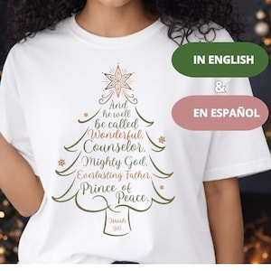 Puede incluir: Camiseta blanca con un diseño de árbol de Navidad y el texto "And he well be called Wonderful, Counselor, Mighty God, Everlasting Father, Prince of Peace." El diseño incluye una estrella y el texto "Isaiah 9.6".