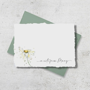 May include: A white stationery card with a watercolor daisy illustration and the handwritten text "a note from Mary." The card is on a sage green envelope, perfect for sending a personalized message.
