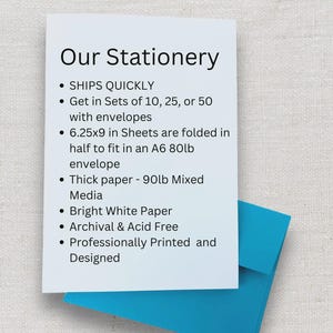 May include: A white card with the text "Our Stationery" and bullet points describing the product's features. The card is partially covering a bright blue envelope. The paper is 6.25x9 inches.