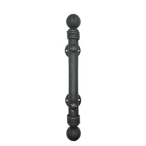 May include: A dark gray metal door handle featuring a cylindrical bar with a textured finish. The handle has spherical finials at both ends, ribbed collars, and two circular mounting plates secured with hammered-style rivets at the top and bottom.