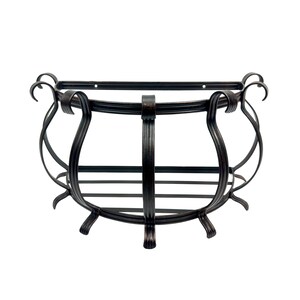 May include: A semi-circular wall-mounted shelf constructed from dark bronze-toned metal. The frame features curved, scroll-like supports and a slatted base. The back edge is flat with two visible mounting holes for attachment to a vertical surface.