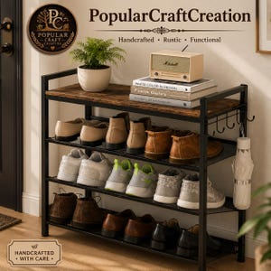 May include: A four-tier shoe rack with a black metal frame and dark wood-grain shelves. The unit holds various shoes, a potted green plant, a beige radio, and books. A white umbrella hangs from a side hook. Text includes PopularCraftCreation.