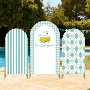 May include: Three decorative arch-shaped panels with golf-themed designs. One panel has vertical stripes, another has a gingham pattern, and the third features an argyle pattern. The center panel has text that reads "Luck Mastered His first year".
