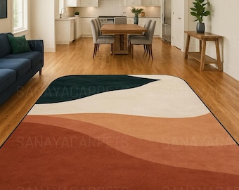 May include: A rectangular area rug with a wave-like design in shades of dark teal, cream, orange, and rust. The rug is placed on a hardwood floor in a living room setting. The text "SANAYACARPETS" is printed on the rug.