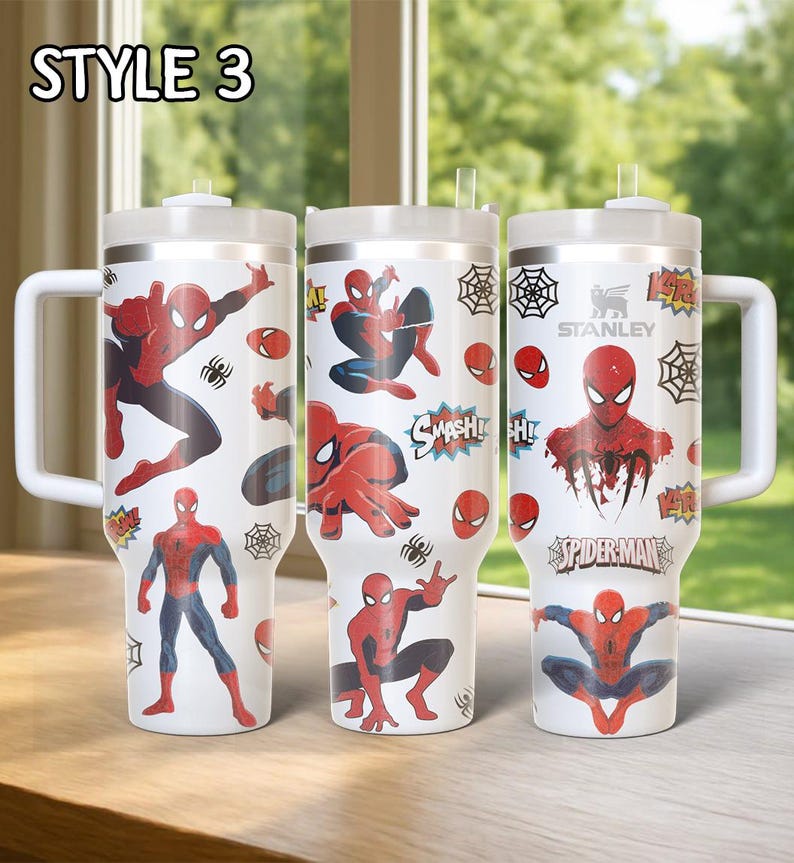 May include: Three white insulated tumblers with Spider-Man graphics. Each tumbler features a different design with Spider-Man in action poses, spiderwebs, and the Spider-Man logo. The tumblers have white handles and lids.