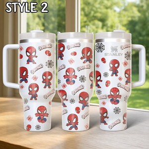May include: Three white insulated tumblers with a Spider-Man design. Each tumbler features a repeating pattern of Spider-Man illustrations, spiderwebs, and the word "Spider-Man". The tumblers have white handles and lids.