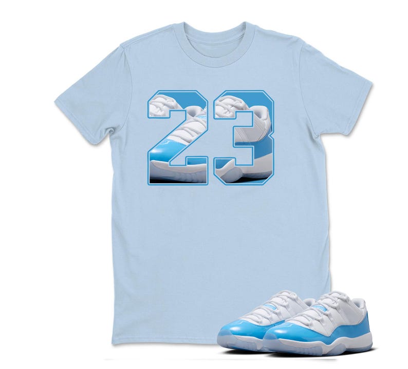 May include: A light blue t-shirt with the number "23" in a white and light blue design. The number is filled with an image of a light blue and white sneaker. A pair of light blue and white sneakers are in front of the shirt.