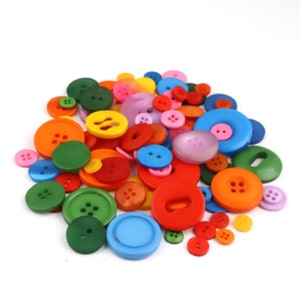 May include: A large assortment of colourful plastic buttons in various shapes and sizes. The buttons are a mix of red, orange, yellow, green, blue, purple, and pink.