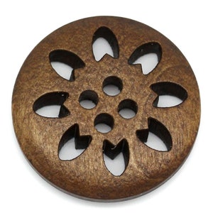 May include: A brown wooden button with a decorative cut-out design resembling a flower. The button has a smooth, slightly shiny finish.
