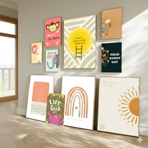 May include: A collection of framed art prints with various designs and text. The prints include a monkey with text, a rabbit with a balloon, an elephant, a sun, a rainbow, and the words "Life Good" and "Read Every Day". The color palette includes pink, yellow, and green.