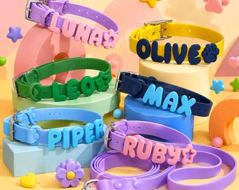 以下が含まれることがあります： LUNA、OLIVE、LEO、MAX、PIPER、RUBYという名前が浮き彫りのブロック体で綴られた、6本のカラフルなシリコン製ペット用首輪と1本のリードのセット。花、星、肉球などの装飾的なパーツが各首輪に取り付けられています。