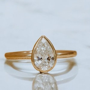 Pear Moissanite Engagement Ring: Bezel Set 14K Gold Solitaire