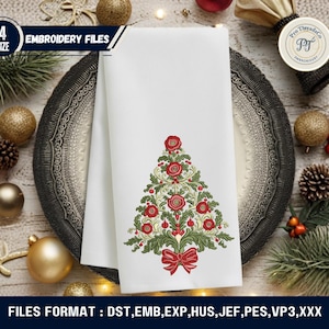 May include: White Christmas-themed towel with an embroidered Christmas tree design in red, green, and cream colors. The towel is folded and placed on a decorative plate, surrounded by Christmas ornaments and greenery. The image includes the text "EMBROIDERY FILES".
