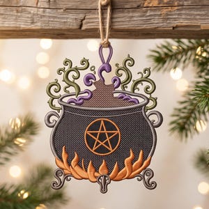 May include: A hanging ornament shaped like a black cauldron with a textured surface. It features an orange pentagram on the front, orange flames at the base, and swirling green and purple smoke rising from the top, suspended by a jute twine loop.