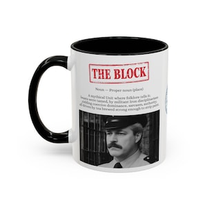 May include: A white ceramic mug with a black handle and interior. The mug features the text "THE BLOCK" in a red rectangle, along with a definition and a black and white image of a man with a mustache.
