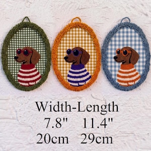 May include: Three oval wall hangings featuring embroidered dachshunds wearing sunglasses and striped sweaters. Each piece has a gingham background and a textured border. The dimensions are 7.8 inches in width and 11.4 inches in length.