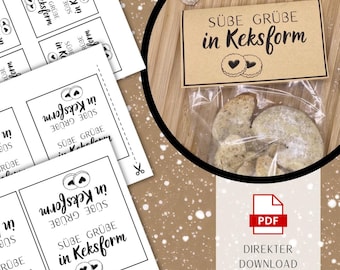 May include: A close-up image features a clear plastic bag filled with cookies, accompanied by a kraft paper tag that reads "SÜBE GRÜBE in Keksform." Several white labels with the same text and cookie illustrations are also visible. A PDF download icon is present.