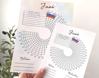 May include: Two white paper habit trackers for the month of June, featuring a circular grid design with numbered days from 1 to 31. The sheets include sections for daily goals, a tracker for habits, and a space labeled Notizen for notes.