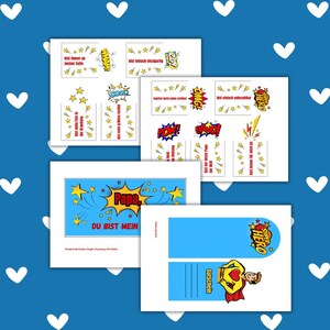 May include: A collection of printed cards with superhero and comic book themes. The cards feature phrases like "Papa, you are my hero" and "Super Hero." The color scheme includes blue, yellow, and red, with star and explosion graphics.
