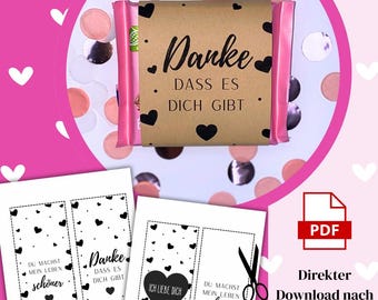 May include: A pink and brown gift with the German text "Danke dass es dich gibt" and black heart accents. The image includes printable bookmarks with German text and a PDF icon, surrounded by pink and silver confetti.