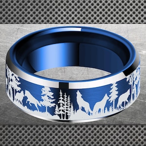 May include: A blue ring with a silver band and a forest and wolf design. The ring features a detailed landscape with trees and wolves howling at the moon. The ring is a stylish accessory.
