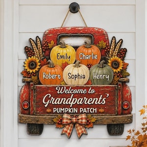 May include: A red truck-shaped wooden door sign featuring five pumpkins labeled with the names Emily, Charlie, Robert, Sophia, and Henry. The sign reads Welcome to Grandparents' PUMPKIN PATCH and is decorated with sunflowers, wheat, and a plaid bow.
