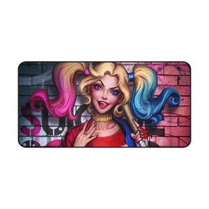 May include: A rectangular mousepad featuring a vibrant illustration of a character with blonde pigtails, blue eyes, and red lipstick. She is holding a baseball bat and is set against a graffiti-covered brick wall. The word "SUICIDE" is partially visible.