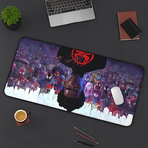 May include: A rectangular mousepad featuring a vibrant illustration of multiple Spider-Man characters. The design includes a central portrait of Miles Morales, with a cityscape silhouette at the bottom. The mousepad is black with a white border.