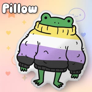 May include: A plush pillow shaped like a cartoon frog wearing a sweater. The frog is green with a yellow, white, purple, and black sweater. The word "Pillow" is written in white, bubble letters in the upper left corner.