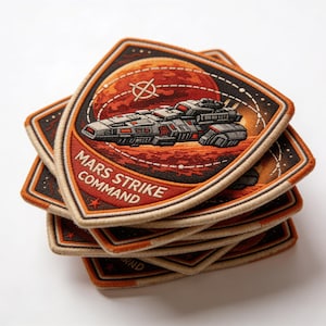 May include: A stack of embroidered patches featuring a spaceship design over a red planet. The patches have a diamond shape with the text "MARS STRIKE COMMAND" in white letters on a red background. The patches are bordered with tan and black stitching.