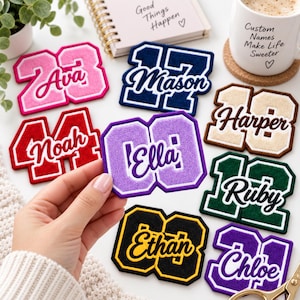 May include: A collection of varsity-style chenille patches featuring various numbers and names including Ava, Mason, Harper, Noah, Ella, Ruby, Ethan, and Chloe. Each patch displays a bold number with a script name layered over the center.