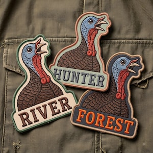 May include: Three embroidered patches featuring turkey heads with blue skin, red wattles, and brown feathers. Each patch includes text at the bottom: one reads RIVER in brown, one reads HUNTER in dark blue, and one reads FOREST in orange letters.