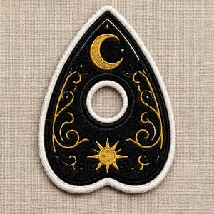 May include: A teardrop-shaped embroidered patch featuring a black background with gold thread detailing. The design includes a crescent moon at the top, a central circular cutout, and a sunburst at the bottom, all framed by a thick white border.